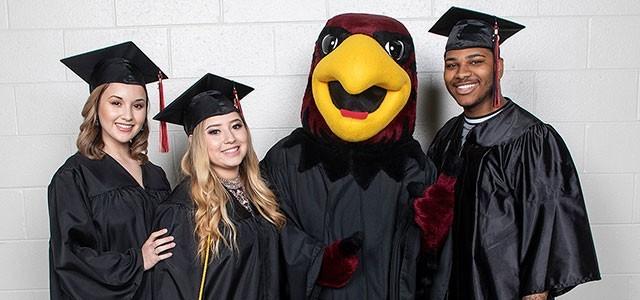 Rudy the Red Hawk with graduates